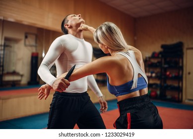 Woman makes punch to the throat, self-defense - Powered by Shutterstock