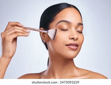Woman, makeup brush and blush in studio, beauty and grooming products on white background. Female person, cosmetics tools and foundation or highlighter powder, skincare and facial treatment for glow