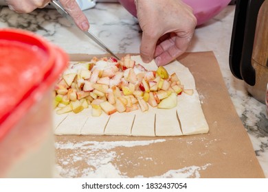 Woman Making Apple Pie On Parchment Paper On Marble Kitchen Table