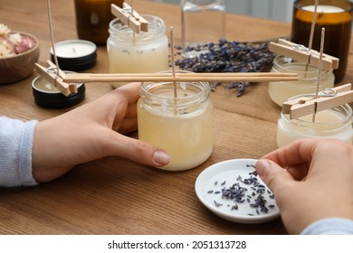 Woman making aromatic candles at wooden table, closeup - Shutterstock ID 2051313728