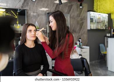 Woman making beauty and make up treatment in a saloon. Concept about beauty and people