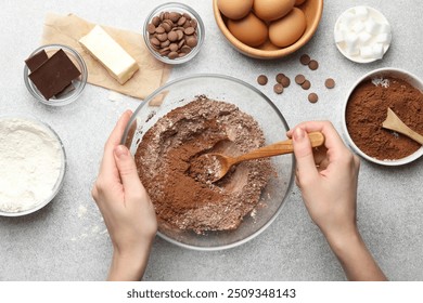 Woman making chocolate dough at light table, top view - Powered by Shutterstock