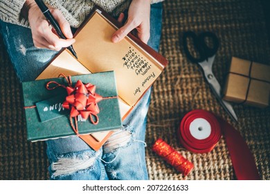 Woman Making Christmas, New Year Check List On 2022 Year At Notebook. 