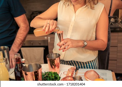 Woman Making A Cocktail At A Home Party.