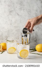 Woman Making Cold Gin Tonic On Light Background