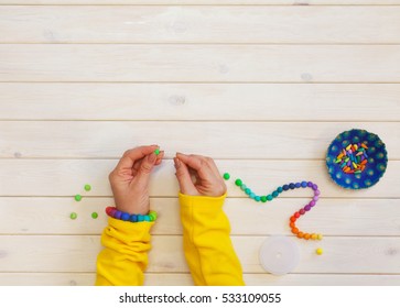 Woman Making Colored Beads. Polymer Clay. Background Of White Wood.