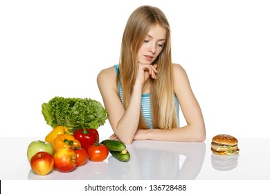 Woman Making Decision Between Healthy Food And Fast Food, Over White Background