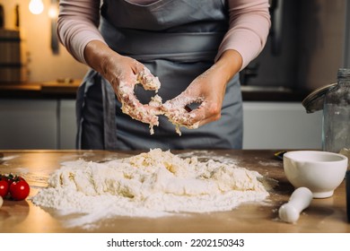 Woman Making Dough In Home Kitchen