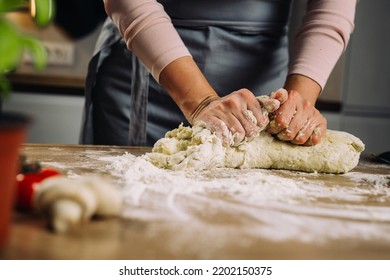 Woman Making Dough In Home Kitchen