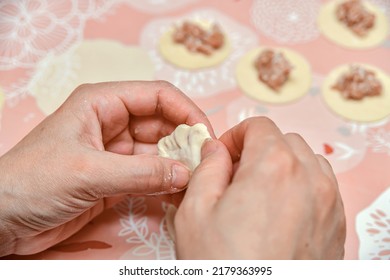 Woman Making Dumplings At Home In The Kitchen