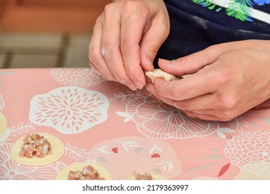 Woman Making Dumplings At Home In The Kitchen