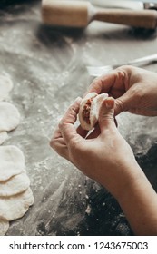 Woman Making Dumplings On Table