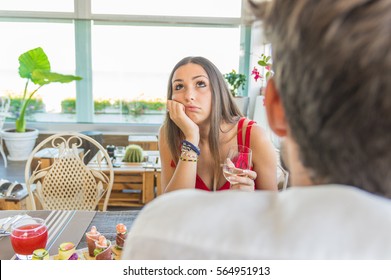 Woman making an exasperated expression gesture on a bad date 