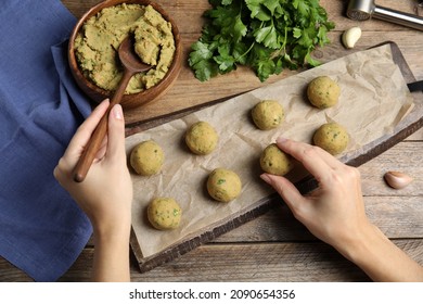 Woman Making Falafel Balls At Wooden Table, Top View