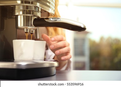 Woman Making Fresh Espresso In Coffee Maker