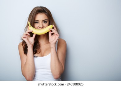 A Woman Making Fun With A Banana