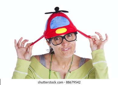 Woman Making A Funny Face With A Propeller Beanie Hat (isolated On White)