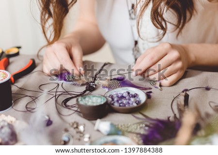 Woman making handmade gemstone jewellery, home workshop. Artisan woman creates jewellery. Art, hobby, handcraft concept