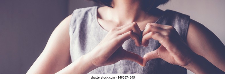 Woman making hands in heart shape, heart health insurance,social responsibility, donation, happy charity volunteer, world heart day, organ donor, appreciate, world mental health, cancer day,compliment
