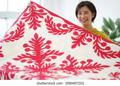 A woman making a Hawaiian quilt 
