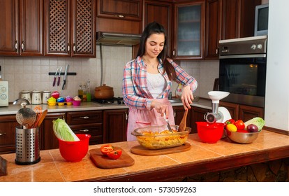 Woman Making Healthy Food Standing Smiling In Kitchen.
Portrait Of Happy, Smiling Mother.