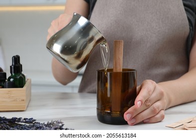 Woman Making Homemade Candle At Table In Kitchen, Closeup