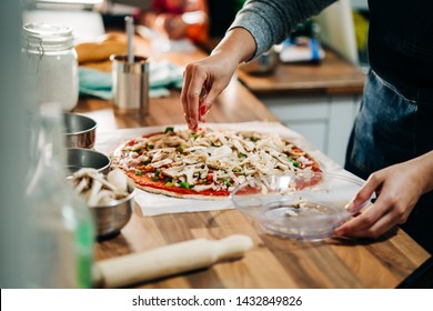 Woman Making Homemade Vegetarian Pizza