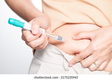 Woman making hormonal therapy injection into her belly. Close up syringe pen. Concept infertility. Treatment IUI Intra – Uterine Insemination and ICSI.
 - Shutterstock ID 2175235943