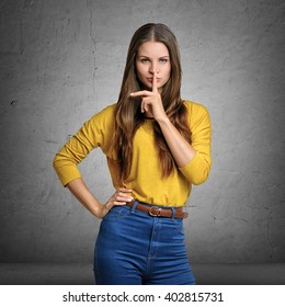 Woman Making A Hush Gesture With Her Index Finger On Lips