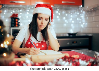 
Woman Making a List Planning a Christmas Party at Home. Party organizer writing down all the important menu ingredients
