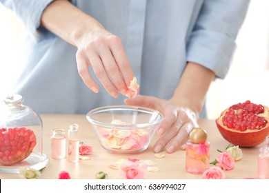 Woman Making Natural Perfume With Rose Petals, Closeup