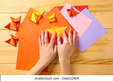 Woman Making Origami Fox At Table