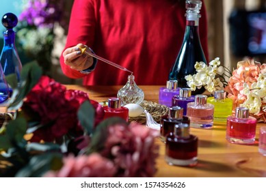 Woman Making Perfume With Test Tubes In Craft Workshop 