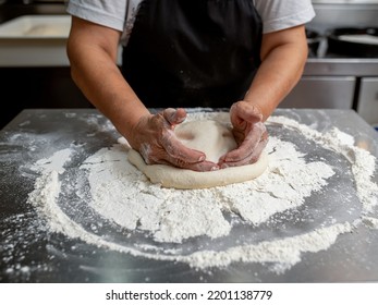 Woman Making Pizza Dough On Stainless Steel Counter