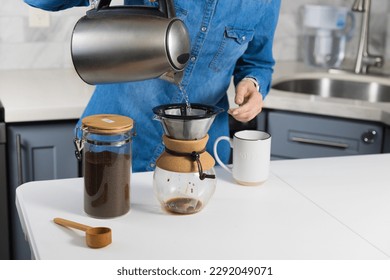 Woman making a pour over coffee at home - Shutterstock ID 2292049071