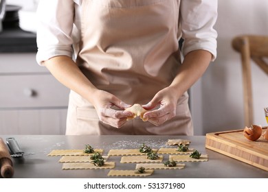 Woman Making Ravioli On Table