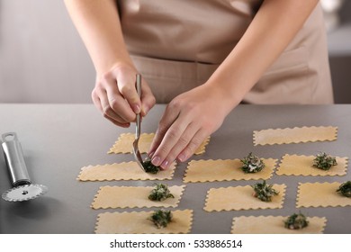 Woman Making Ravioli On Table