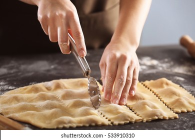 Woman making ravioli on table - Powered by Shutterstock