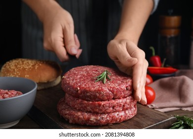 Woman Making Raw Hamburger Patty At Wooden Table, Closeup