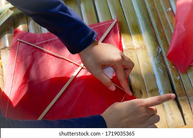 The Woman Is Making A Red Paper Kite.