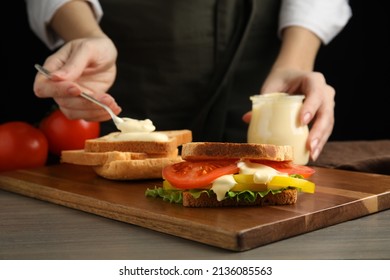 Woman Making Sandwich With Mayonnaise At Wooden Table, Closeup