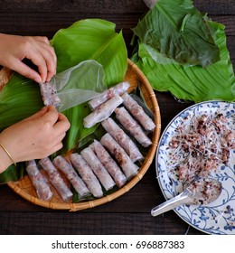 Woman Making Spring Rolls Or Cha Gio At Home, Homemade Food Stuffing From Meat And Wrapper By Rice Paper, Hand Rolling Vietnamese Egg Roll On Green Leaf Background