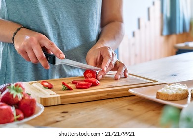 Woman Making Summer Strawberry Sandwich. Female Hands Cutting Ripe Red Strawberry On Cutting Board. Healthy Eating, Fruit Dieting Brunch.