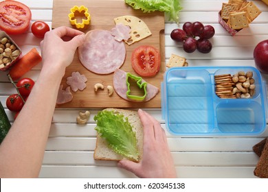 Woman Making Tasty Sandwich On Table