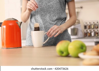 Woman Making Tea In The Kitchen