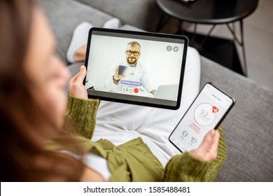 Woman making video call to a doctor using digital tablet, feeling bad at home. Concept of telemedicine and patient counseling online