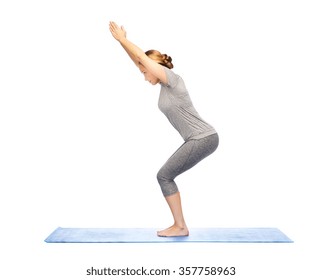 Woman Making Yoga In Chair Pose On Mat