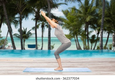 Woman Making Yoga In Chair Pose On Mat