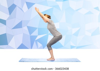 Woman Making Yoga In Chair Pose On Mat