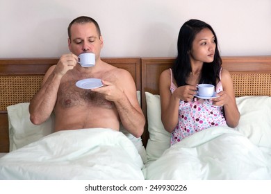 Woman With Man In Bed Drinking Tea